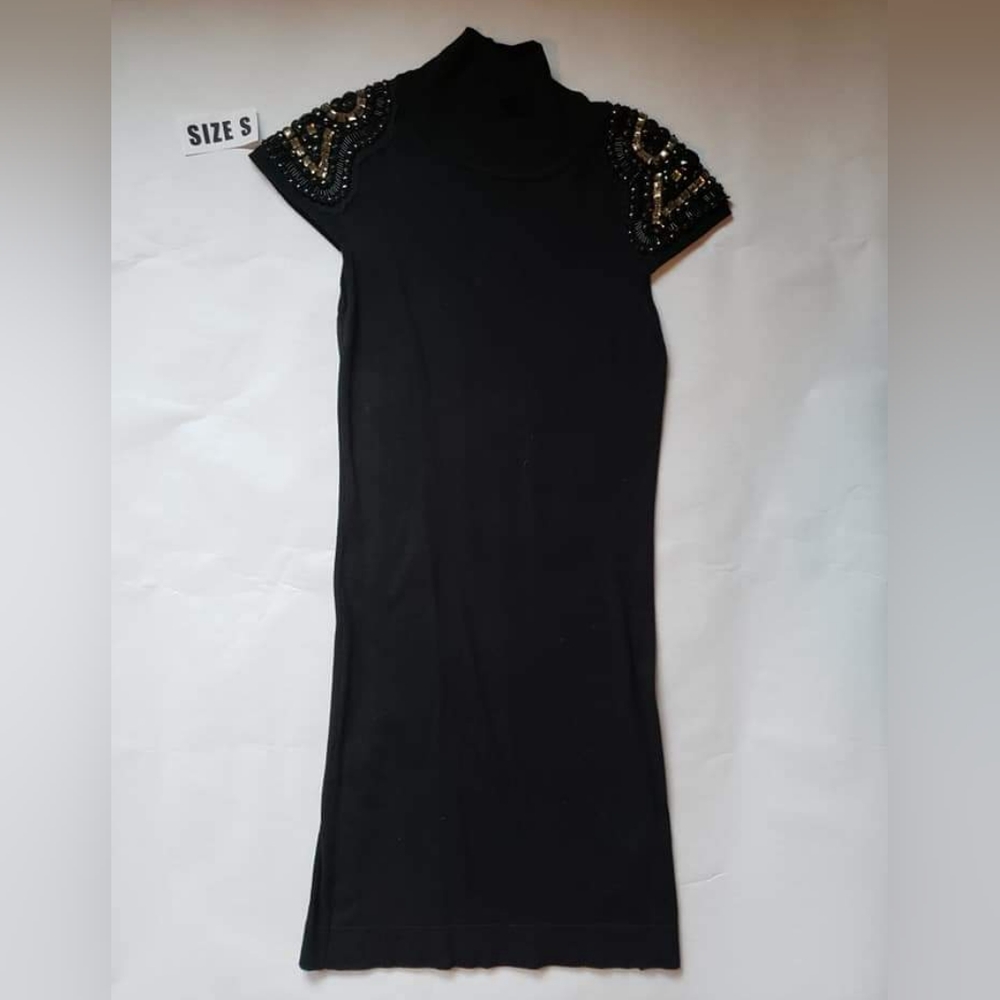 Black fitted turtleneck sweater dress with beads and gems on shoulders